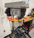 Drill press safety guarding installed in a workshop setting