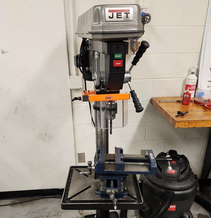 Drill press safety guarding installed in a workshop setting