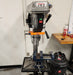 Drill press safety guarding installed in a workshop setting