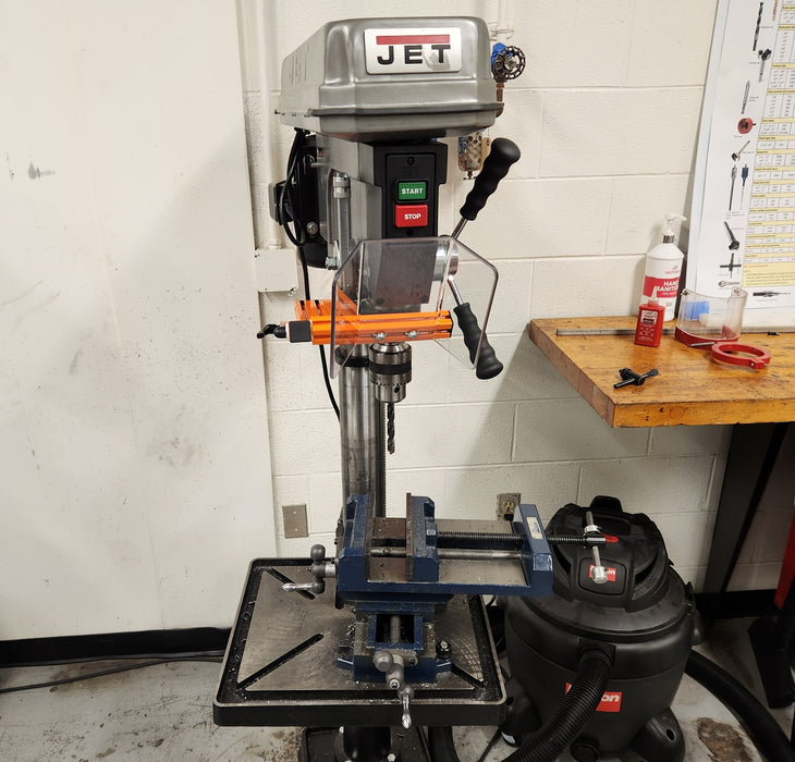Drill press safety guarding installed in a workshop setting