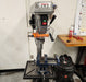 Drill press safety guarding installed in a workshop setting