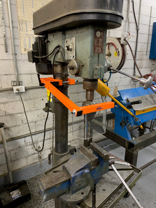 Drill press chuck safety guard installed in a machine shop